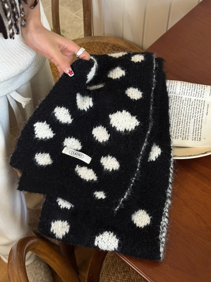 Close-up of the Black Ivory scarf's fuzzy knit texture and contrast edge