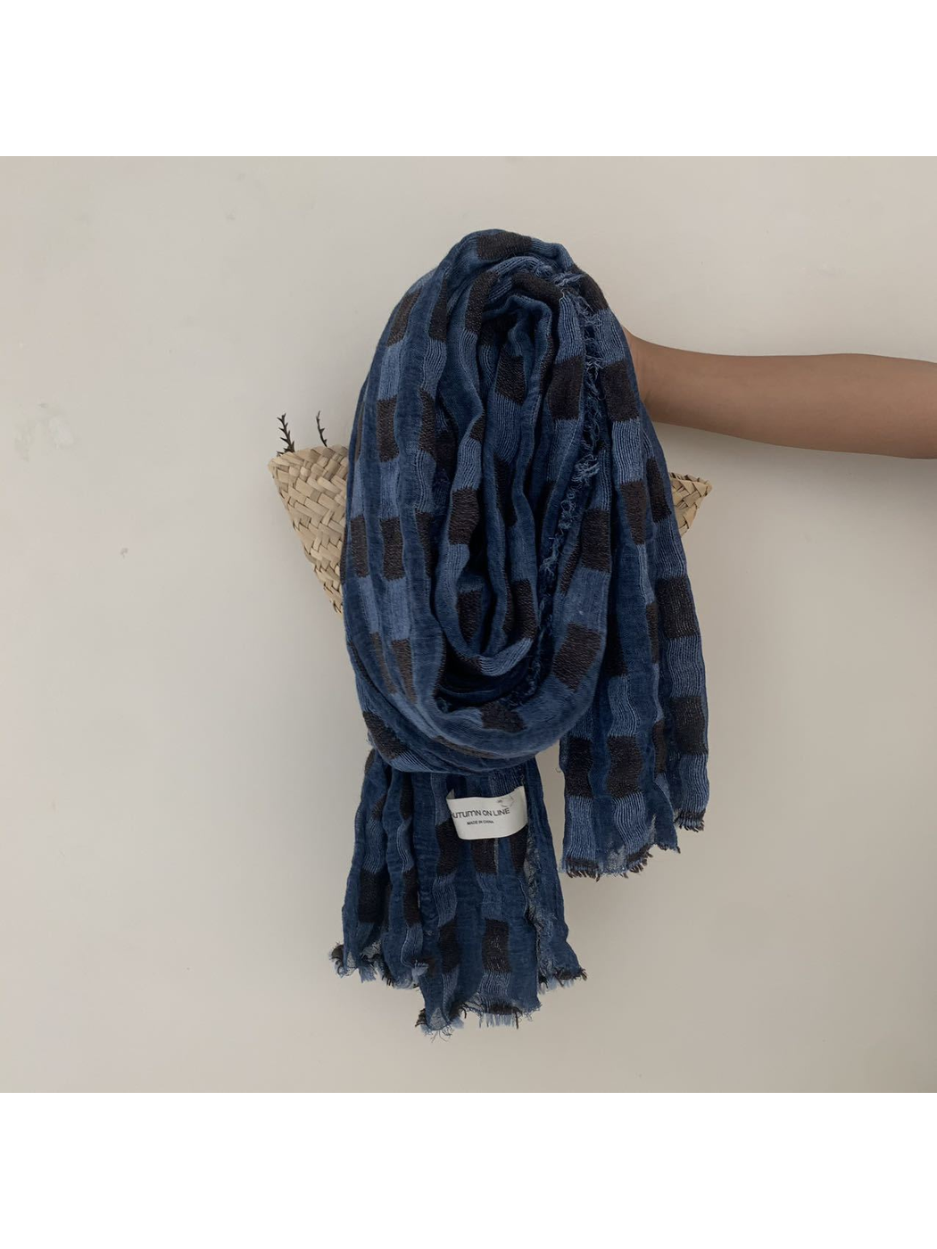 Blue scarf with rectangular block pattern and frayed edges