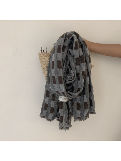 Gray scarf with rectangular block pattern and frayed edges
