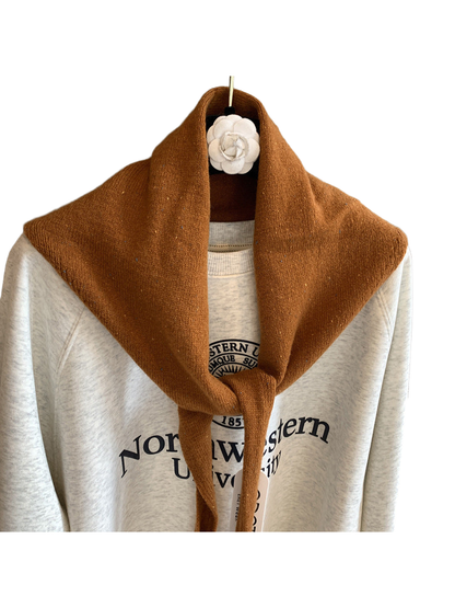 Close-up of the caramel scarf's fine knit texture and colorful flecks