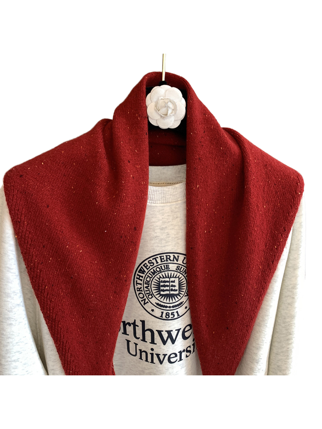 Close-up of the red scarf's fine knit texture and colorful flecks