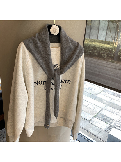 Dark Gray triangle scarf tied over a cream sweatshirt