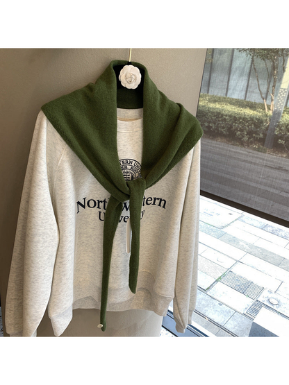 Dark Green triangle scarf tied over a cream sweatshirt