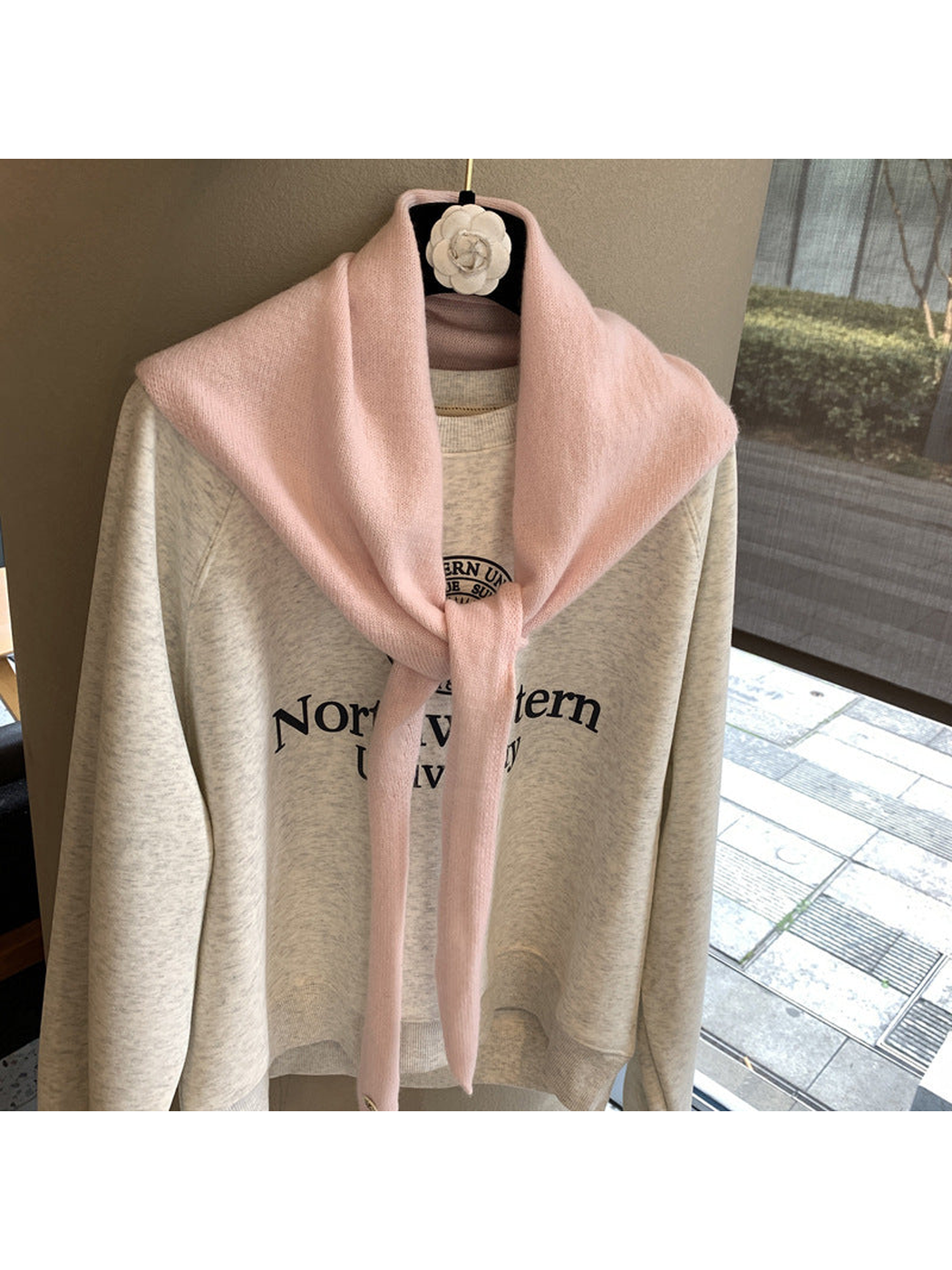 Light Pink triangle scarf tied over a cream sweatshirt