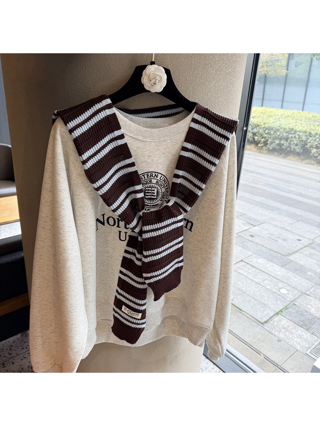 Dark Brown and ivory striped knit scarf tied over a sweatshirt