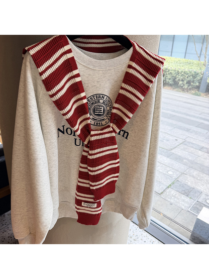 Close-up of the red and ivory striped knit pattern and tied front