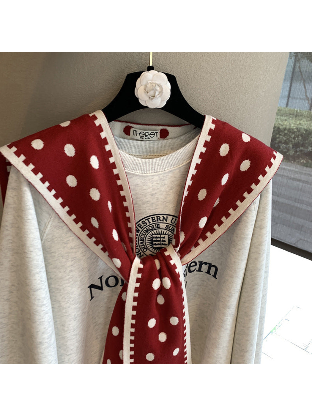 Close-up of the Red scarf's polka dots, contrast border and tied drape