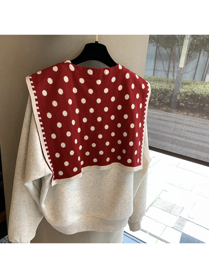 Red polka-dot scarf spread across the shoulders, back view