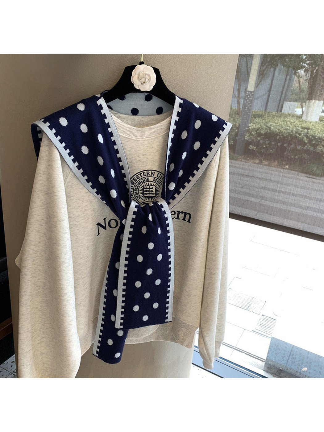 Navy polka-dot scarf with contrast border in a tied front drape