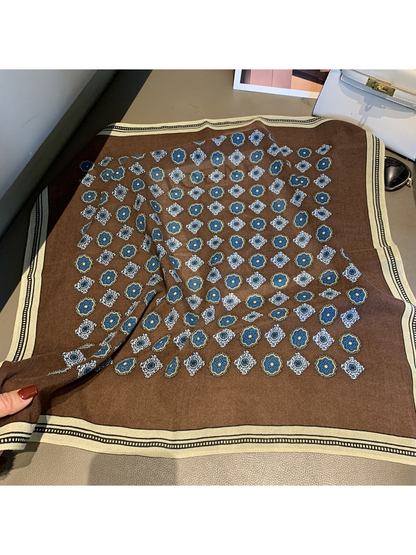 Brown square scarf with blue and white floral medallions and a cream border