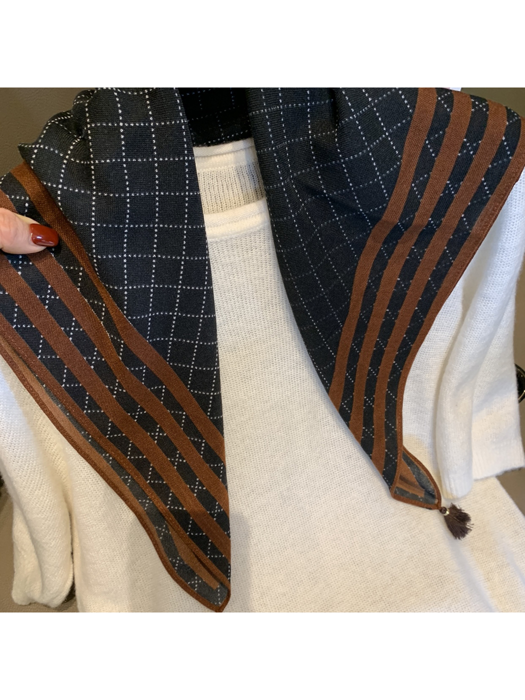 Close-up of the Navy scarf's dotted checks and brown striped border