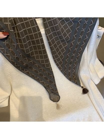 Close-up of the Coffee scarf's striped border and contrasting corner tassels
