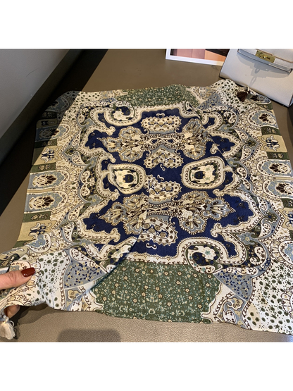 Daisy square scarf with ornate blue, green and cream pattern laid open