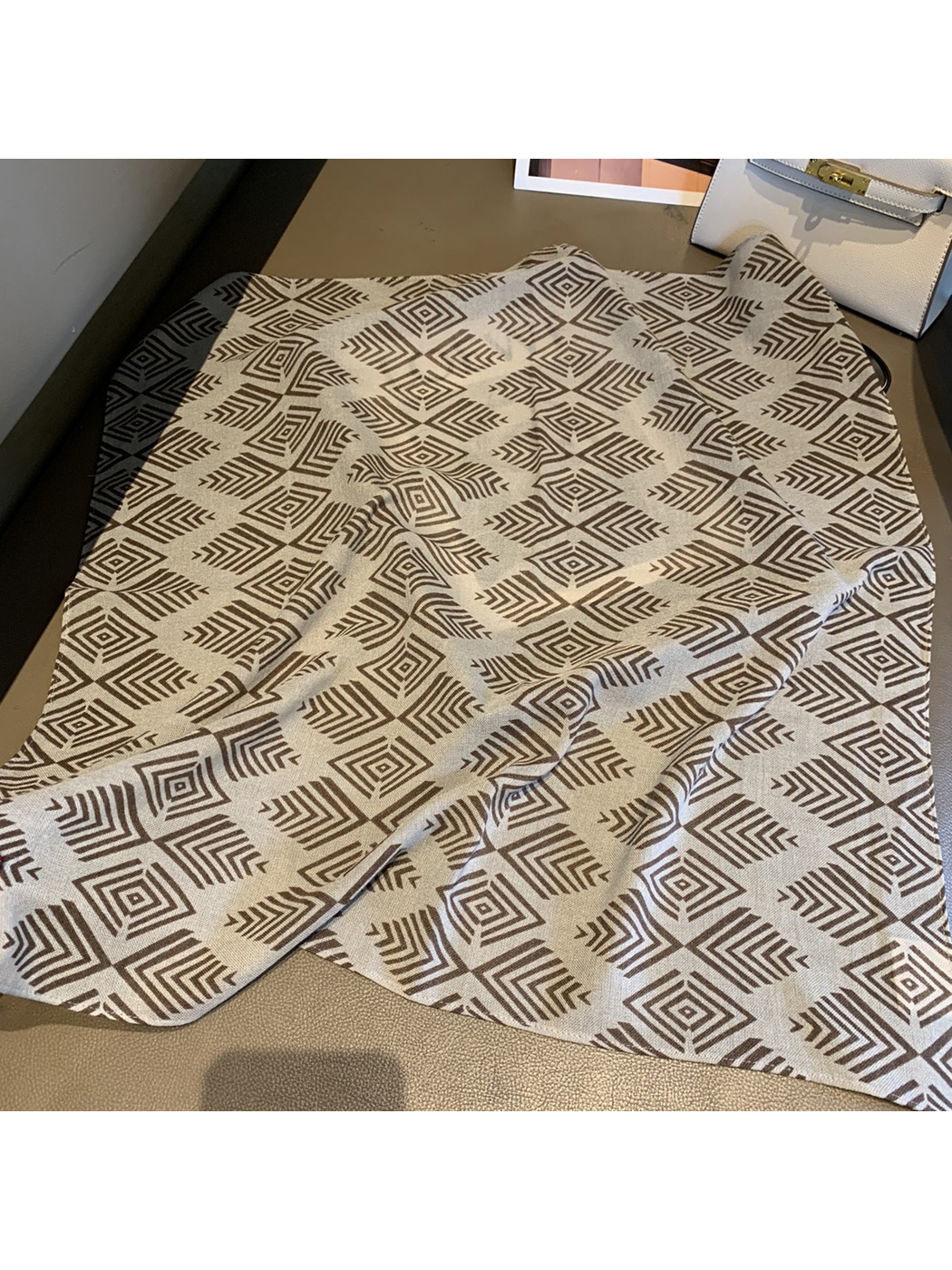 Fretwork Grid square scarf with brown geometric motifs laid open