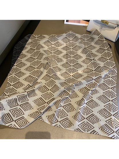 Fretwork Grid square scarf with brown geometric motifs laid open