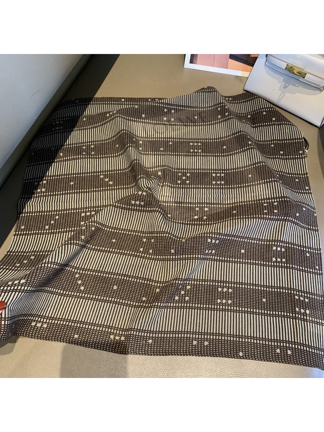 Grid square scarf with fine brown plaid lines and small accents laid open
