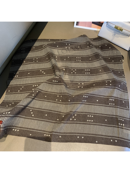 Grid square scarf with fine brown plaid lines and small accents laid open