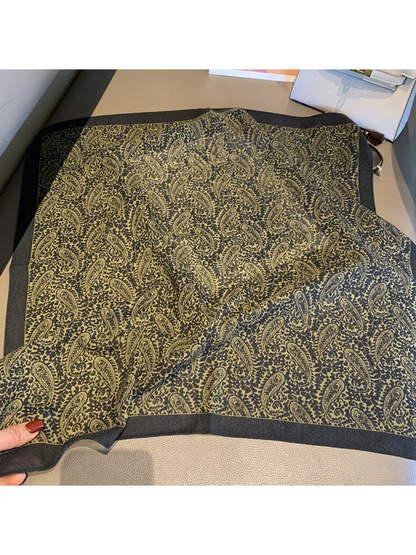 Paisley square scarf with olive motif and dark border laid open