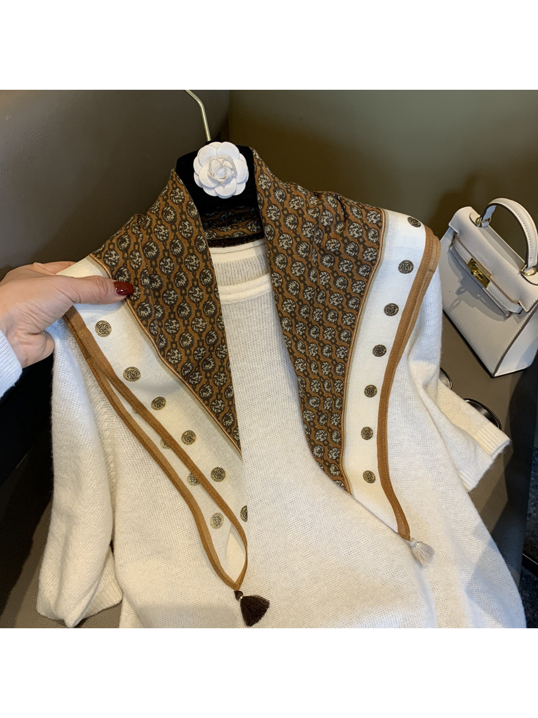 Camel-brown patterned square scarf draped over a white top