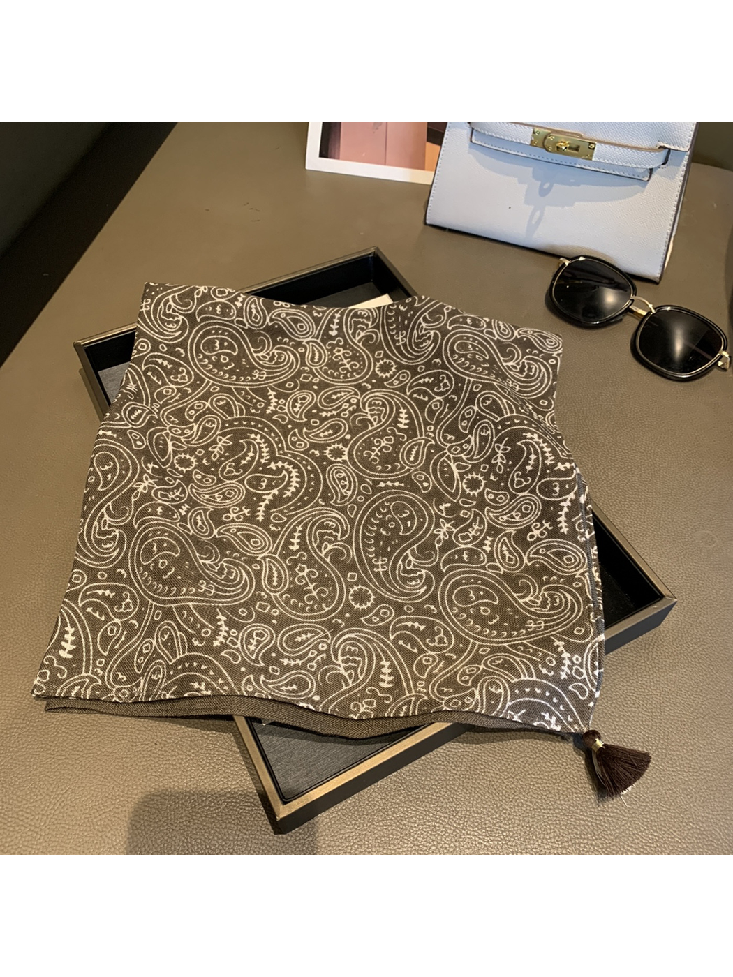 Army Green paisley square scarf laid open with a contrasting corner tassel