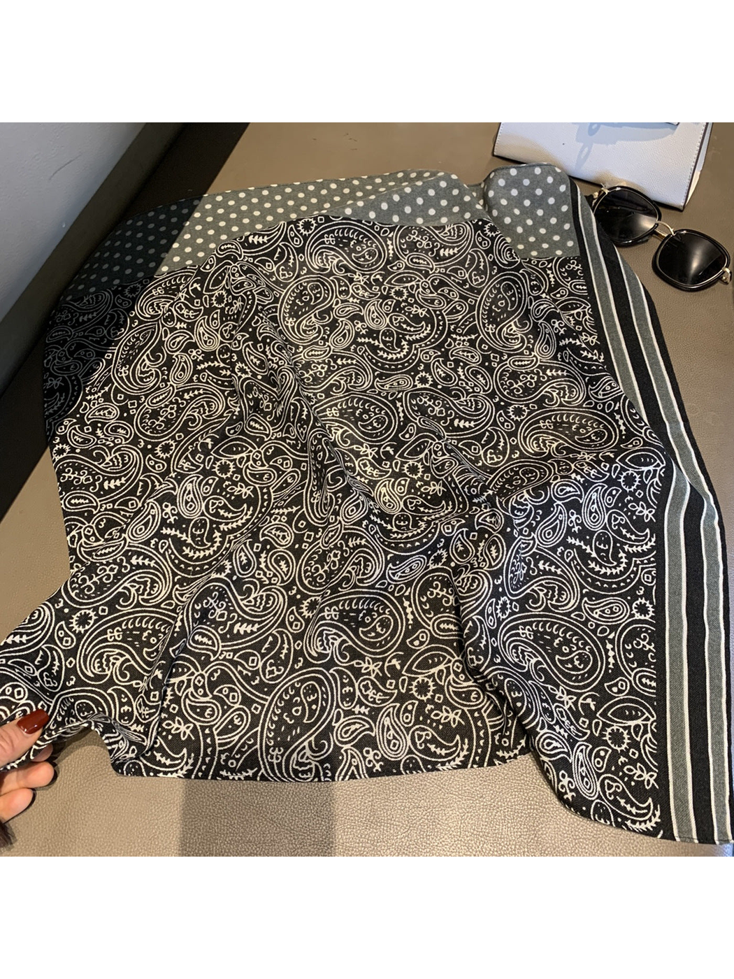 Close view of the Black paisley scarf with striped and polka-dot border sections