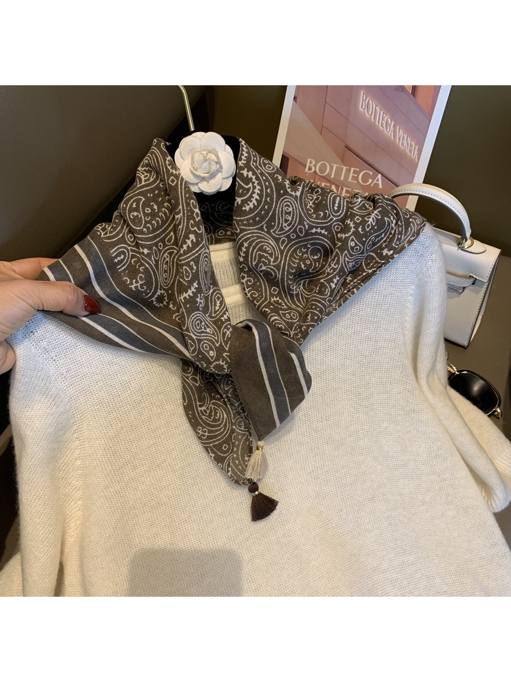 Army Green paisley scarf tied at the neckline over a white sweater
