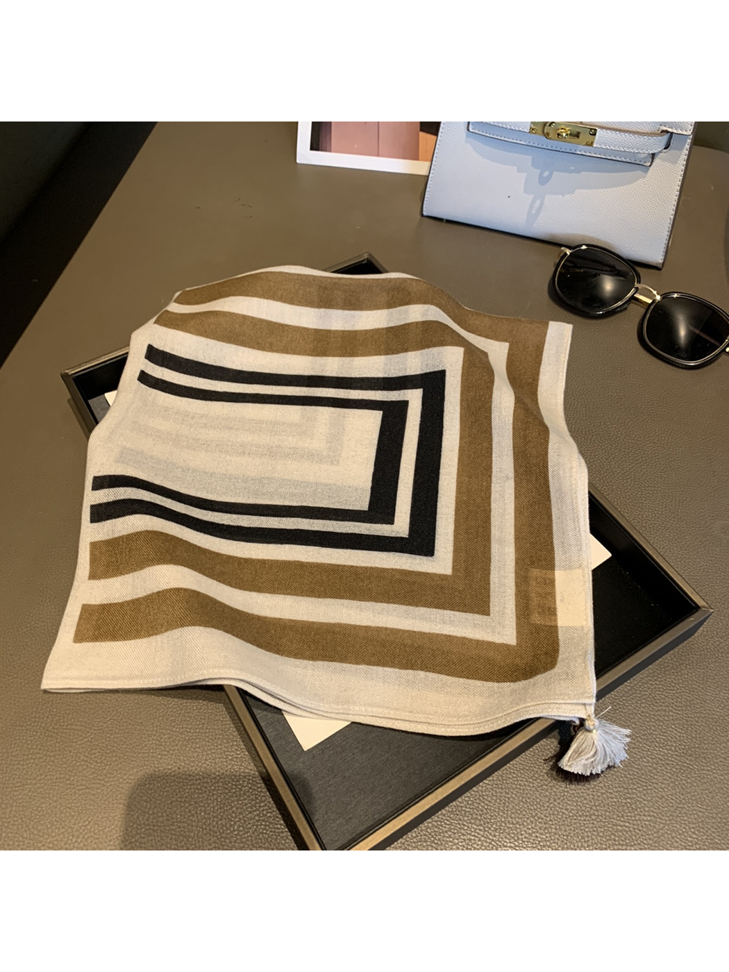 Khaki geometric square scarf with corner tassels, folded view