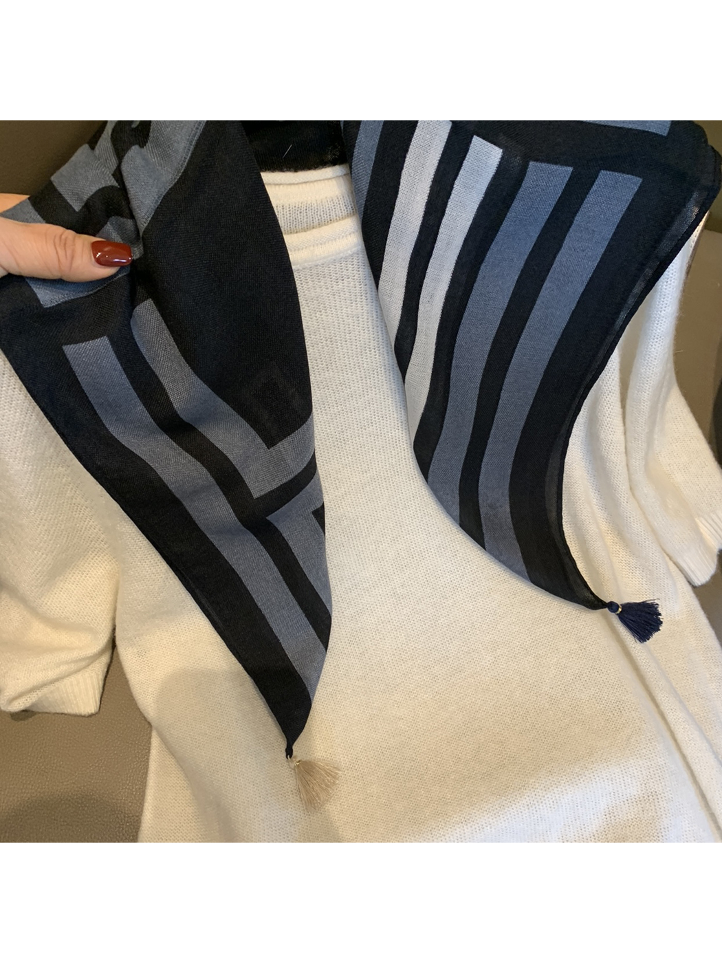 Close-up of the Black Gray scarf's geometric pattern and corner tassels