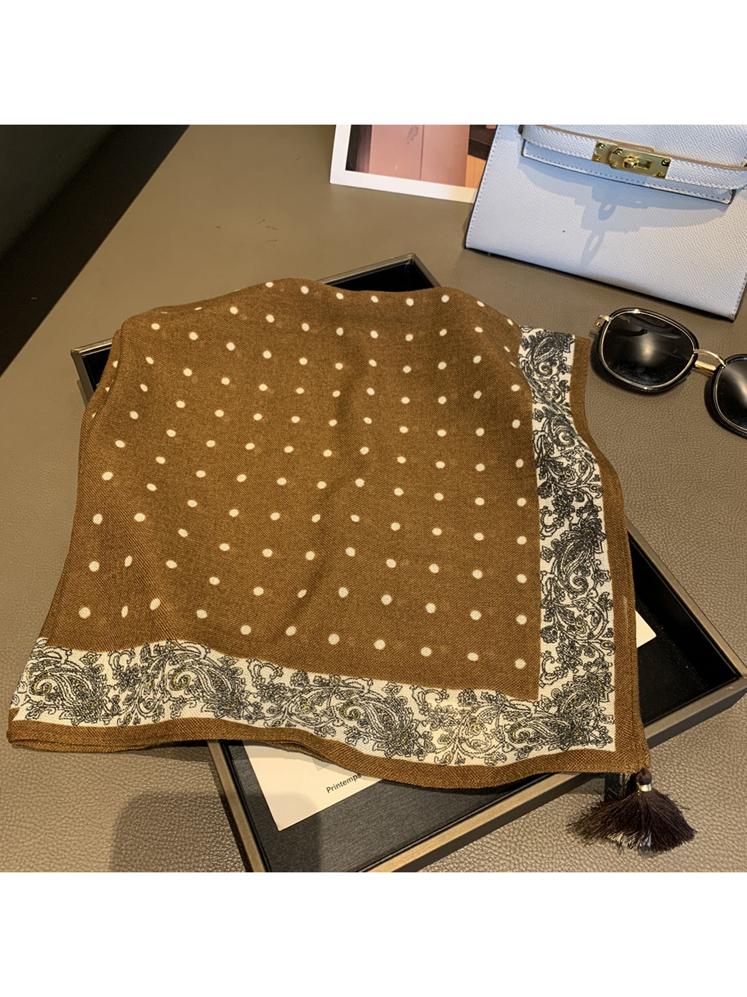 Coffee polka dot square scarf laid flat with paisley border and tassel trim