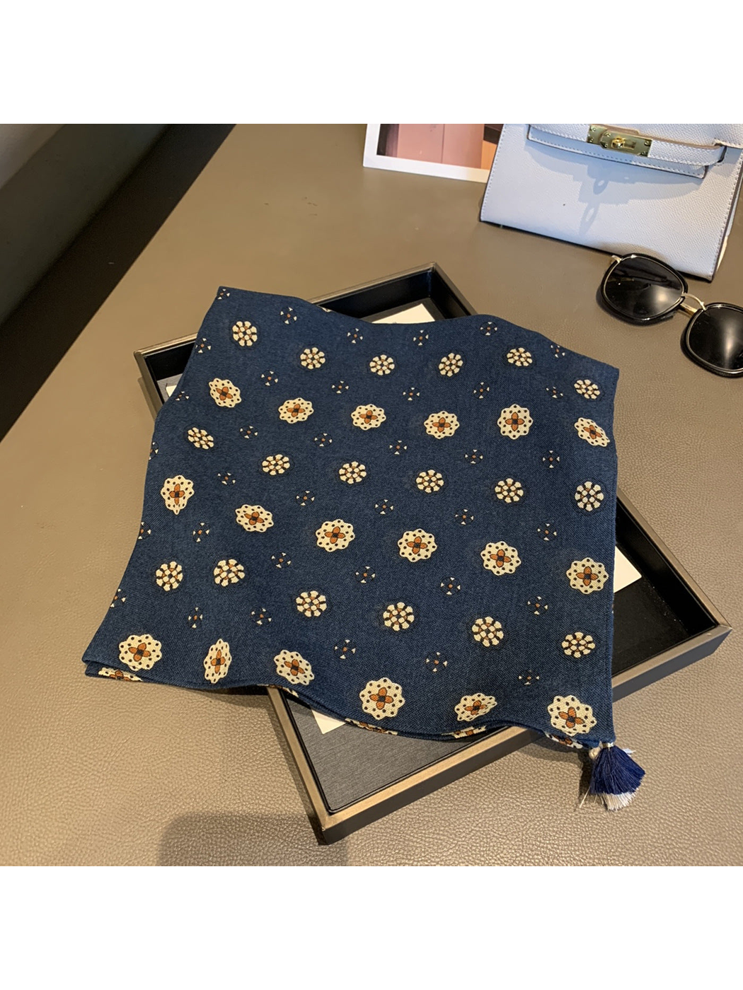 Navy square scarf with floral medallion pattern and corner tassels, laid flat