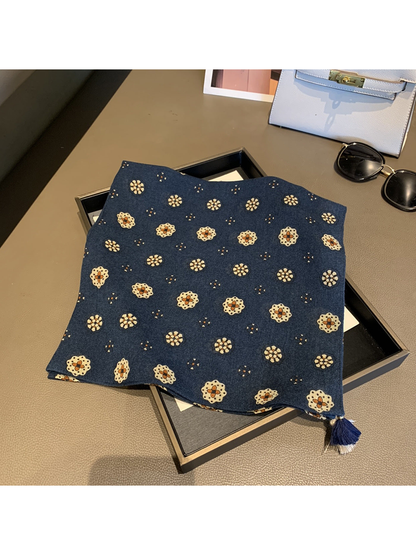 Navy square scarf with floral medallion pattern and corner tassels, laid flat
