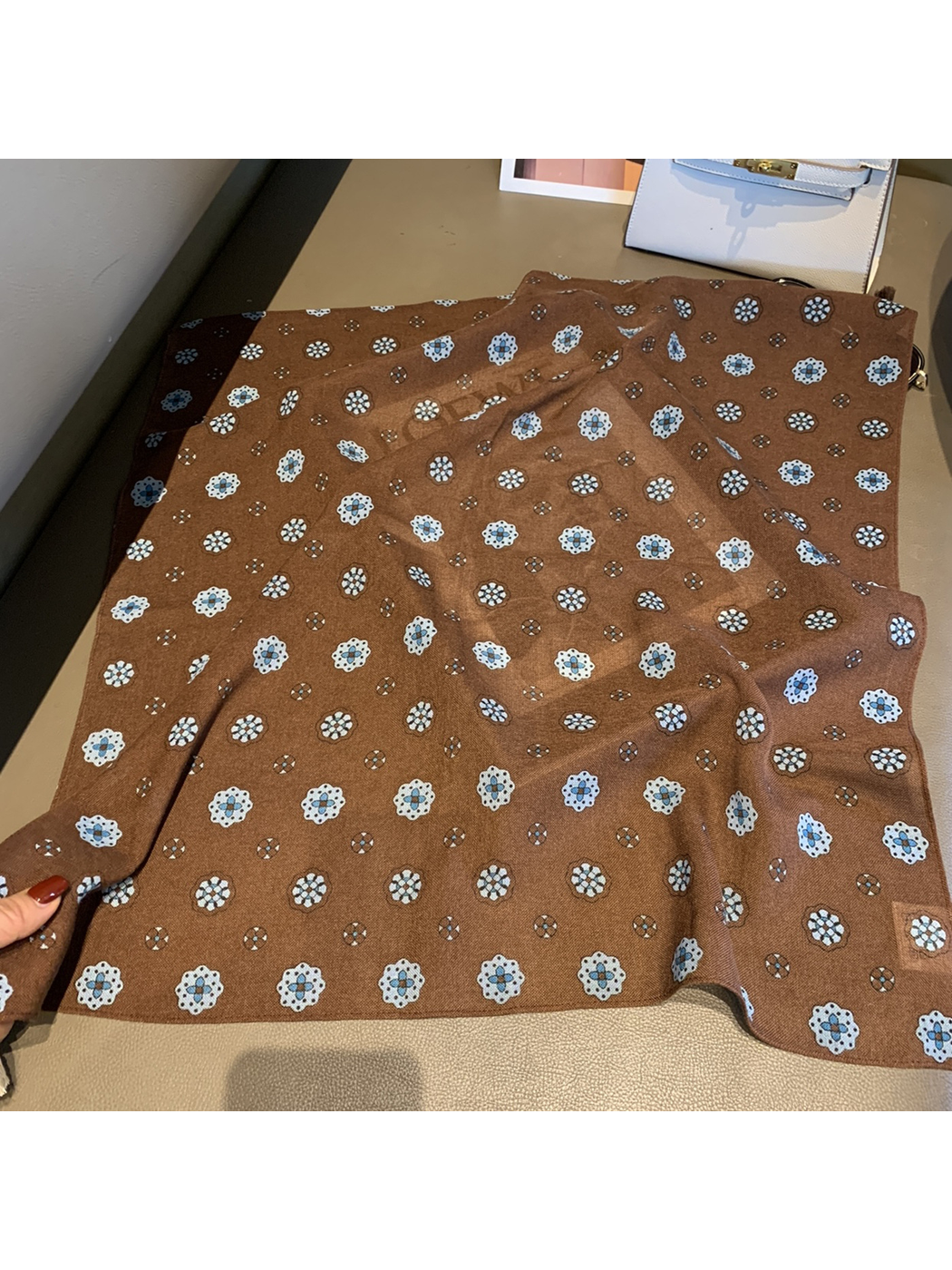 Brown square scarf spread open to show the repeating floral medallion pattern and finished edges