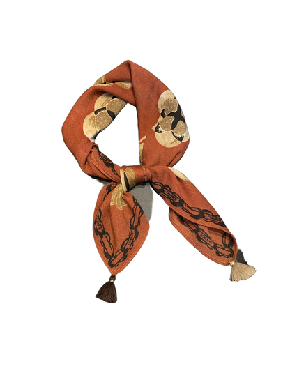 Orange Red floral square scarf tied in a bow with contrasting tassel ends