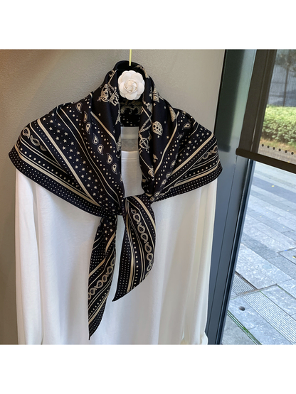Black Beige paisley and star scarf tied over a white top