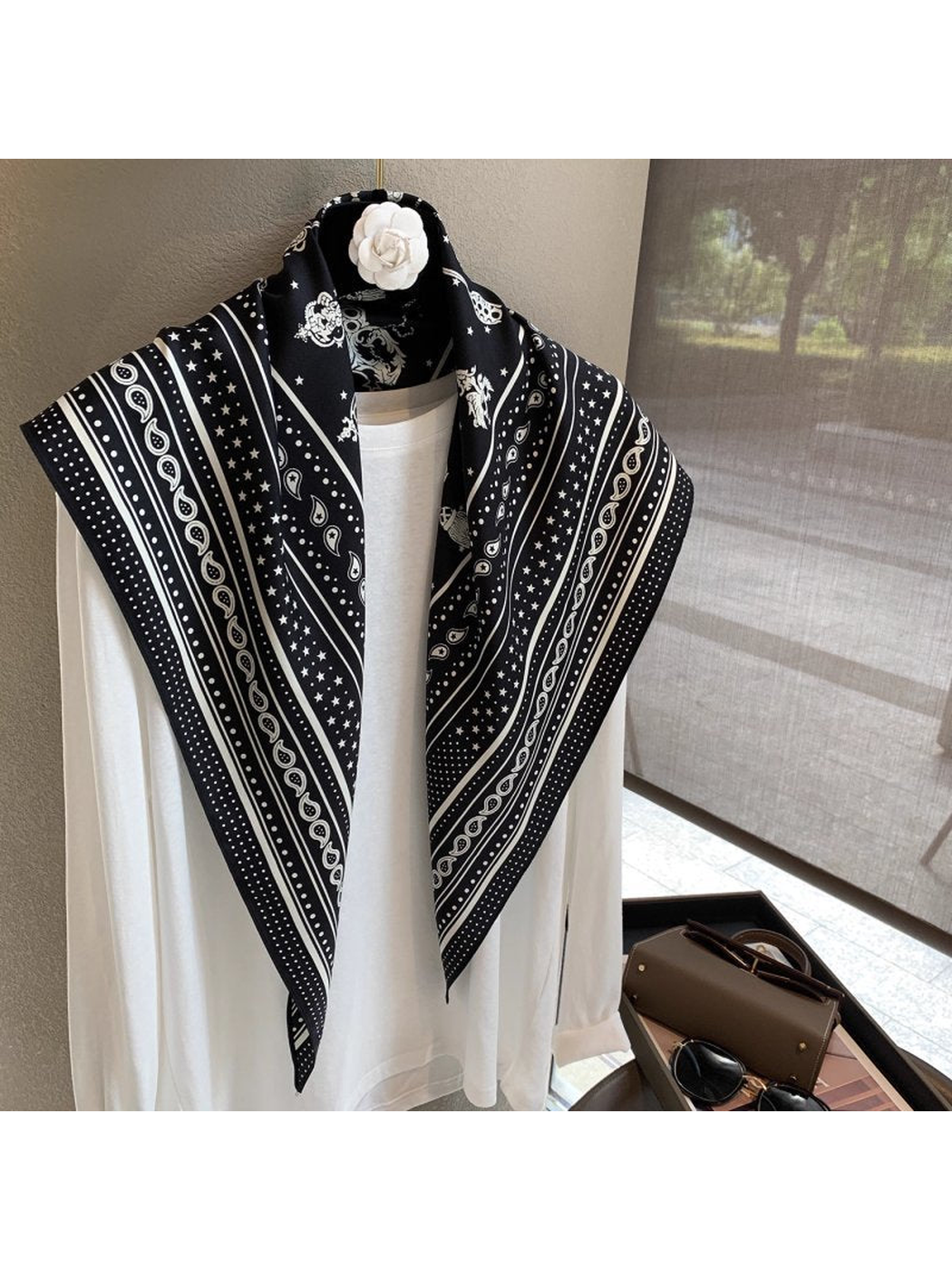 Black White paisley and star scarf draped open over a white top