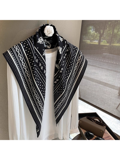 Black White paisley and star scarf draped open over a white top