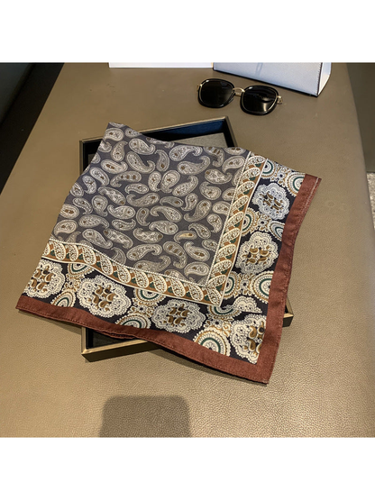 Folded square scarf with gray paisley field and brown floral border