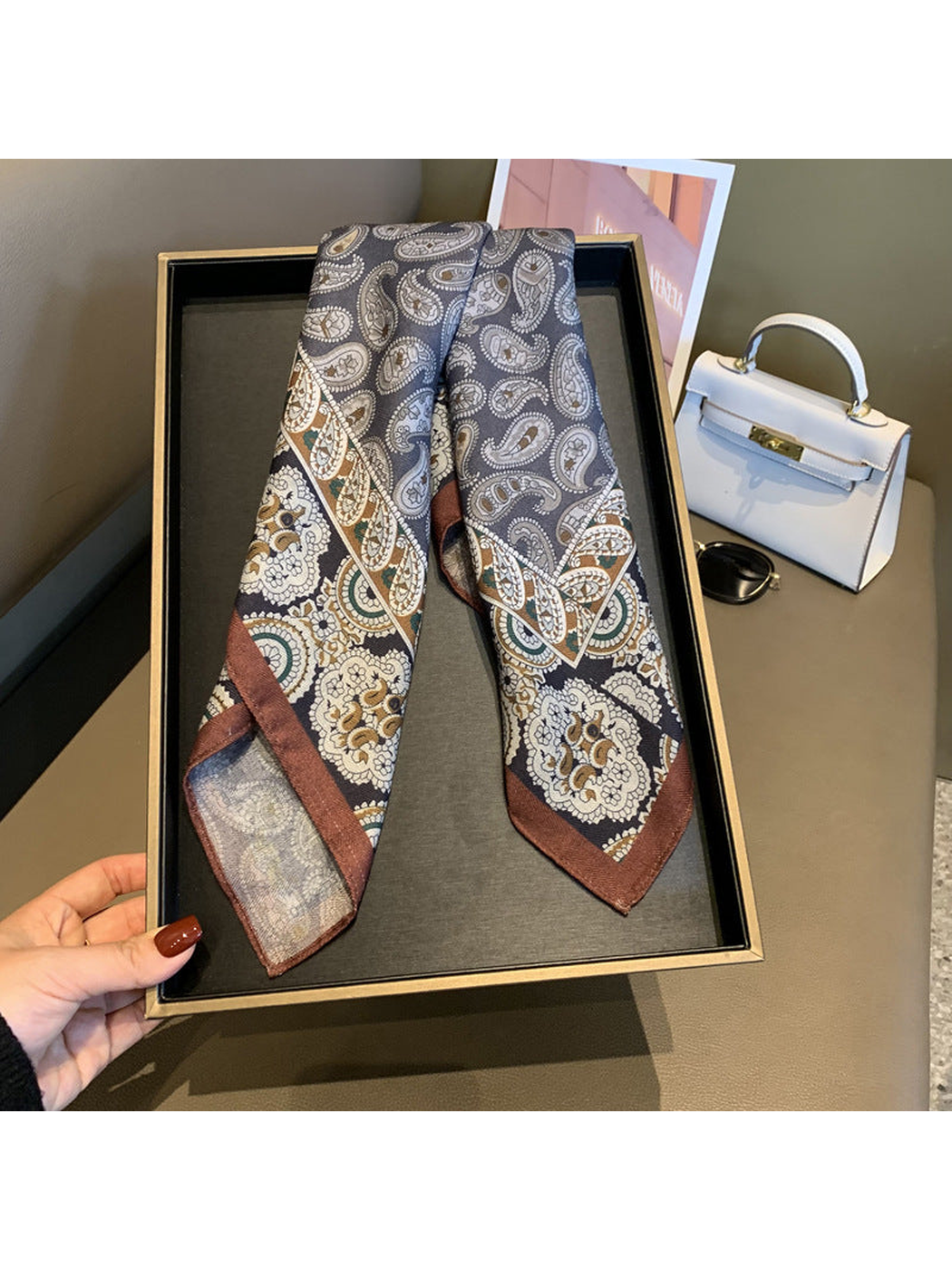 Gray paisley square scarf draped to display its floral-bordered ends