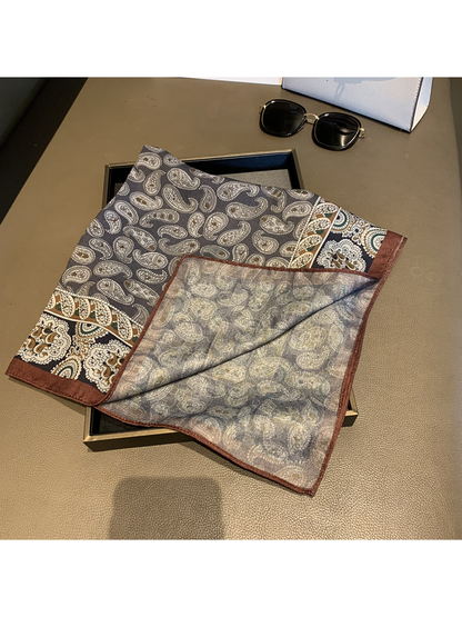 Folded corner revealing the scarf's paler reverse pattern and brown edge