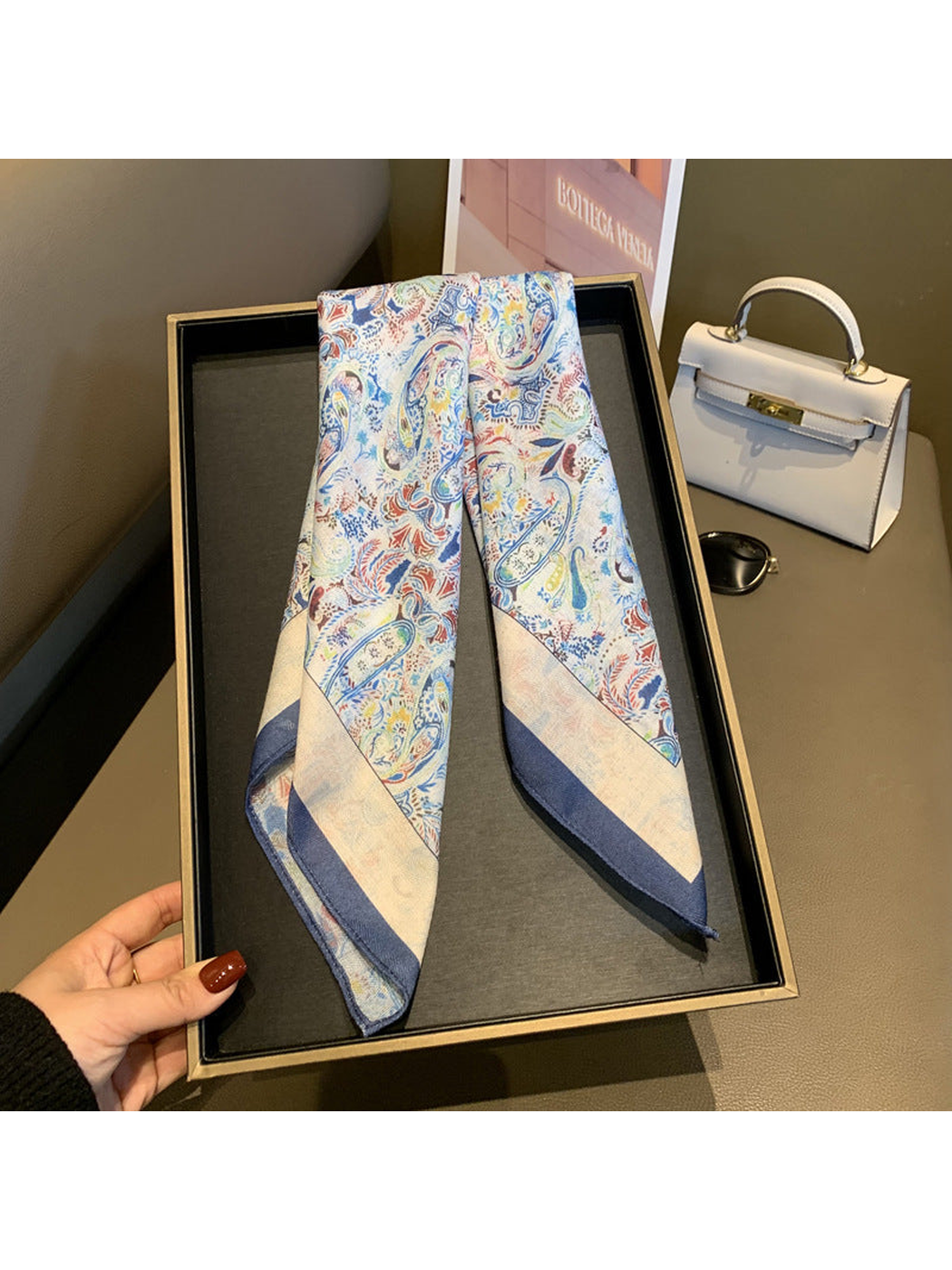 Multicolor paisley scarf folded lengthwise with ivory and navy border