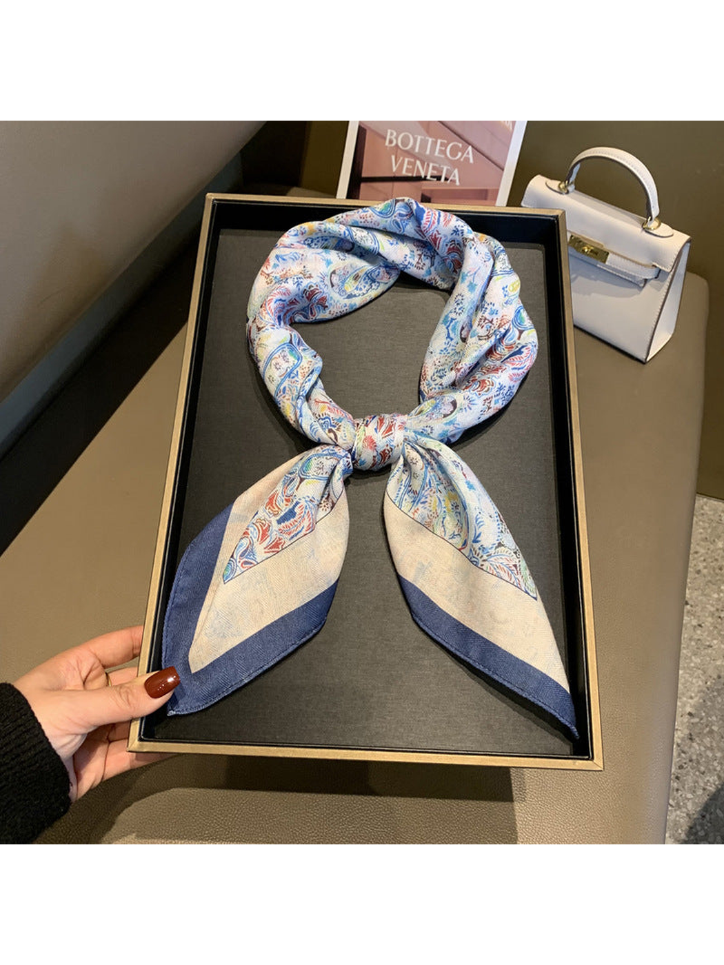 Multicolor paisley scarf styled in a loop with knotted ends