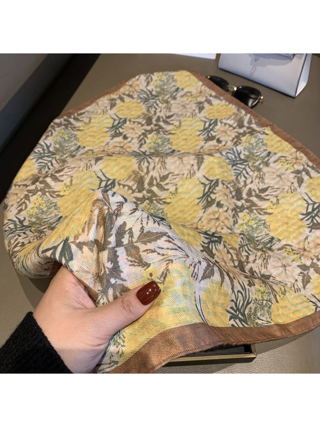 Close-up of the yellow botanical floral print and brown finished border