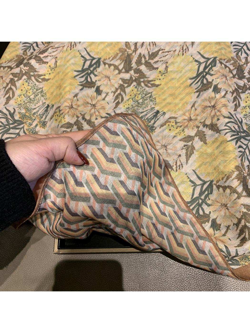 Close-up of the contrasting geometric striped reverse of the floral scarf