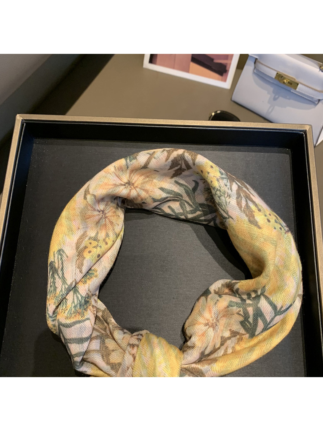 Close-up of the floral scarf's fine diagonal woven-look texture