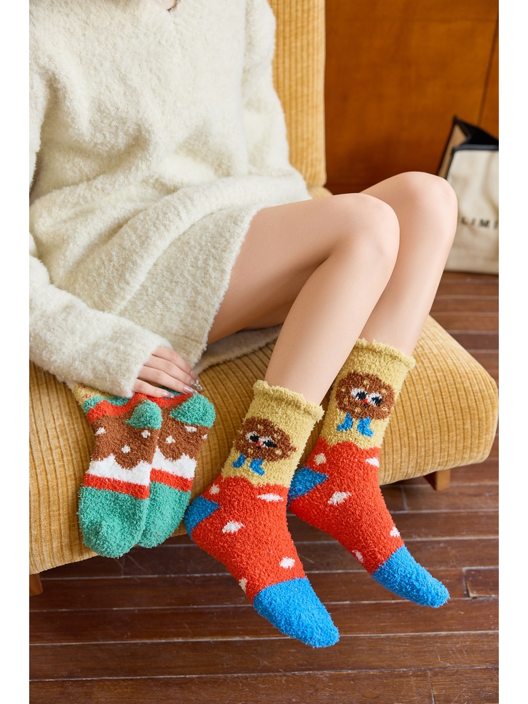 Cookie style fuzzy crew socks worn while Hamburger socks are held beside them