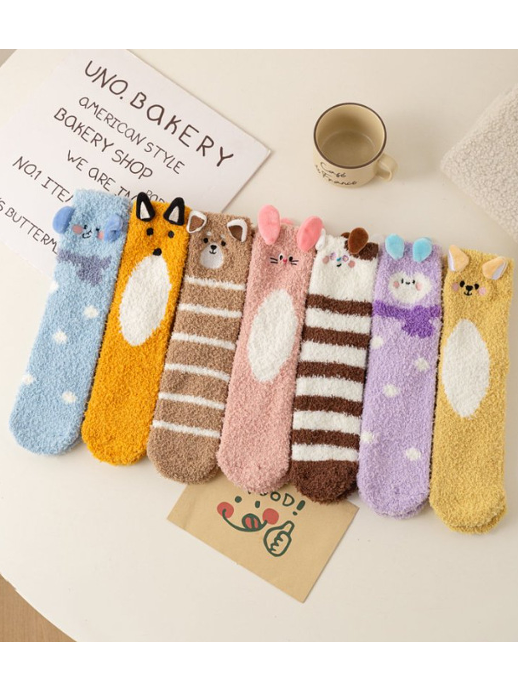 Seven colorful fuzzy animal character sock designs displayed together