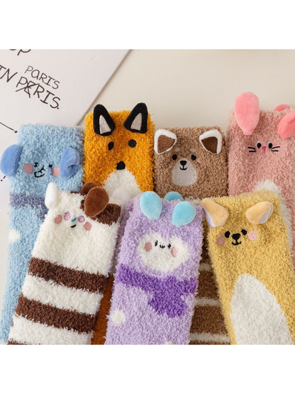 Close group view of colorful fuzzy socks with animal faces and raised ear accents