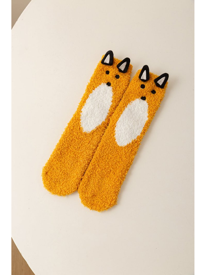 Mustard fuzzy fox character socks with raised black ears and a white belly motif
