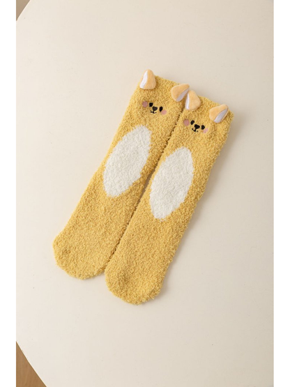 Yellow fuzzy animal character socks with raised ears and a white belly motif