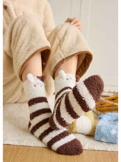 Brown and cream striped animal character socks worn with one sole raised
